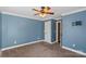 Cozy bedroom with neutral carpet, blue walls, and ceiling fan at 4231 Brushy Knl, York, SC 29745