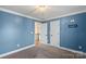 Bedroom featuring neutral carpet, blue walls, and ceiling light fixture at 4231 Brushy Knl, York, SC 29745