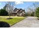 Beautiful two-story brick home with lush green lawn, mature trees, and a long driveway at 4231 Brushy Knl, York, SC 29745