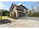 Side view of a two-car garage with a spacious driveway and landscaped surroundings at 4231 Brushy Knl, York, SC 29745
