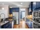 Modern kitchen with blue cabinets, stainless steel appliances, and hardwood floors at 4231 Brushy Knl, York, SC 29745