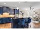 Charming kitchen boasts stylish blue cabinets, granite counters, and a cozy breakfast bar with seating at 4231 Brushy Knl, York, SC 29745