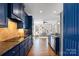 Stylish kitchen with blue cabinets, granite countertops, and hardwood floors, with an open layout at 4231 Brushy Knl, York, SC 29745