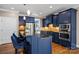 A gourmet kitchen featuring stainless steel appliances, a kitchen island, and sleek blue cabinetry at 4231 Brushy Knl, York, SC 29745