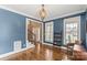 Cozy living room with hardwood floors, blue accent wall, and abundant natural light from large windows at 4231 Brushy Knl, York, SC 29745