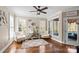 Bright sunroom features natural light, a ceiling fan, and a cozy seating area with plush armchairs at 4231 Brushy Knl, York, SC 29745