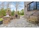 Outdoor kitchen with stone countertops, built-in grill, and wood bench seating. Enjoy outdoor dining and entertaining at 4231 Brushy Knl, York, SC 29745