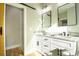 Well-lit bathroom with double vanity, granite countertop, and modern glass enclosed shower at 472 Oak Rd # 114/115/116, Norwood, NC 28128