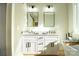 Modern bathroom featuring double vanity sinks, modern light fixtures, and large mirrors at 472 Oak Rd # 114/115/116, Norwood, NC 28128