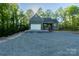 New construction home with a charming facade, attached garage, and a stone driveway lined by tall trees at 472 Oak Rd # 114/115/116, Norwood, NC 28128