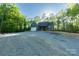 New construction home with a charming facade, attached garage, and a stone driveway lined by tall trees at 472 Oak Rd # 114/115/116, Norwood, NC 28128