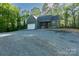 New construction home with a charming facade, attached garage, and a stone driveway lined by tall trees at 472 Oak Rd # 114/115/116, Norwood, NC 28128