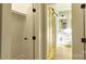 Hallway entrance to a modern bathroom with a white dual vanity, shower, and barn door at 472 Oak Rd # 114/115/116, Norwood, NC 28128