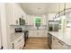 Modern kitchen features white cabinets, stainless appliances, and a center island at 472 Oak Rd # 114/115/116, Norwood, NC 28128