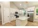 Modern kitchen featuring a center island, stainless steel appliances, and bright lighting at 472 Oak Rd # 114/115/116, Norwood, NC 28128