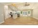 Bright open-concept living space with cathedral ceiling, wood floors, and modern kitchen with center island at 472 Oak Rd # 114/115/116, Norwood, NC 28128