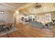 Bright open-concept living space with cathedral ceiling, wood floors, and modern kitchen with center island at 472 Oak Rd # 114/115/116, Norwood, NC 28128