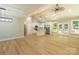 Bright open-concept living space with cathedral ceiling, wood floors, and modern kitchen with center island at 472 Oak Rd # 114/115/116, Norwood, NC 28128