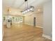 Bright open-concept living space with cathedral ceiling, wood floors, and modern kitchen with center island at 472 Oak Rd # 114/115/116, Norwood, NC 28128