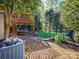 The backyard boasts a large deck, lush green grass, and mature trees at 547 Ashby Dr, Davidson, NC 28036