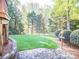 Expansive backyard featuring lush lawn, privacy fence, and mature trees at 547 Ashby Dr, Davidson, NC 28036