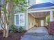 Spacious carport featuring a side door, brick accents, and ceiling mounted storage/tie-down system at 547 Ashby Dr, Davidson, NC 28036