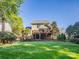 Rear exterior view of the home showcasing a large deck and landscaped backyard at 547 Ashby Dr, Davidson, NC 28036