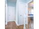 Second floor hallway with hardwood floors and white railings and trim leading to bedrooms at 547 Ashby Dr, Davidson, NC 28036