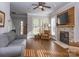 Inviting living room with hardwood floors, fireplace, and large windows overlooking the front yard at 547 Ashby Dr, Davidson, NC 28036
