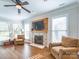 Living room with hardwood floors, a fireplace, and large windows offers an abundance of sunlight at 547 Ashby Dr, Davidson, NC 28036