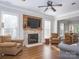 Bright living room featuring a fireplace, hardwood floors, and a view into the dining area at 547 Ashby Dr, Davidson, NC 28036