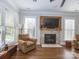 Sun-filled living room showcases hardwood floors, a fireplace, and large windows for ample natural light at 547 Ashby Dr, Davidson, NC 28036
