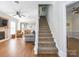 Open-concept living room with hardwood floors, fireplace, and staircase leading to the second floor at 547 Ashby Dr, Davidson, NC 28036