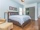 Comfortable main bedroom featuring a sliding barn door leading to the en suite bathroom at 547 Ashby Dr, Davidson, NC 28036