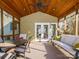 Well-lit screened porch showcasing a ceiling fan, comfortable furniture, and outdoor views at 547 Ashby Dr, Davidson, NC 28036