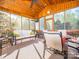 Screened in porch with beautiful wooden accents, ceiling fan, furniture and natural light at 547 Ashby Dr, Davidson, NC 28036