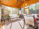 Screened in porch with beautiful wooden accents, ceiling fan, furniture and natural light at 547 Ashby Dr, Davidson, NC 28036