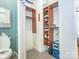 Walk-in closet next to a toilet and sink with multiple shelves and organized storage at 547 Ashby Dr, Davidson, NC 28036