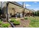 Picture of the backyard, featuring a covered patio, grill area, and lush green lawn at 5854 Crimson Oak Ct, Harrisburg, NC 28075