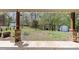 Backyard with view of the fenced yard, trees, and shed from the covered patio at 5854 Crimson Oak Ct, Harrisburg, NC 28075
