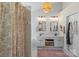 Bright bathroom featuring double sink vanity, decorative lighting, and charming neutral-toned shower curtain at 5854 Crimson Oak Ct, Harrisburg, NC 28075