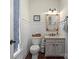 Charming half bath with wainscoting, decorative mirror, and rustic-style vanity at 5854 Crimson Oak Ct, Harrisburg, NC 28075