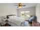 Well-lit bedroom with hardwood floors, a ceiling fan, and a cozy window reading nook at 5854 Crimson Oak Ct, Harrisburg, NC 28075
