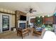 Inviting covered patio boasting stone fireplace, comfortable seating, and stylish decor elements at 5854 Crimson Oak Ct, Harrisburg, NC 28075