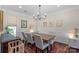 Cozy dining room with hardwood floors, chandelier, and access to backyard views at 5854 Crimson Oak Ct, Harrisburg, NC 28075