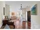 Welcoming foyer with hardwood floors, chandelier, and entry to living spaces at 5854 Crimson Oak Ct, Harrisburg, NC 28075