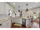 Bright kitchen with white cabinets, granite countertops, and stainless steel dishwasher at 5854 Crimson Oak Ct, Harrisburg, NC 28075