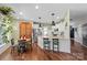 Charming eat-in kitchen with granite countertops, stainless steel appliances, and hardwood floors at 5854 Crimson Oak Ct, Harrisburg, NC 28075