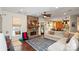 Comfortable living room features a stone fireplace, ample seating, and access to the backyard at 5854 Crimson Oak Ct, Harrisburg, NC 28075