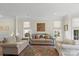Bright and airy living room featuring neutral colors, comfortable seating, and natural light at 5854 Crimson Oak Ct, Harrisburg, NC 28075